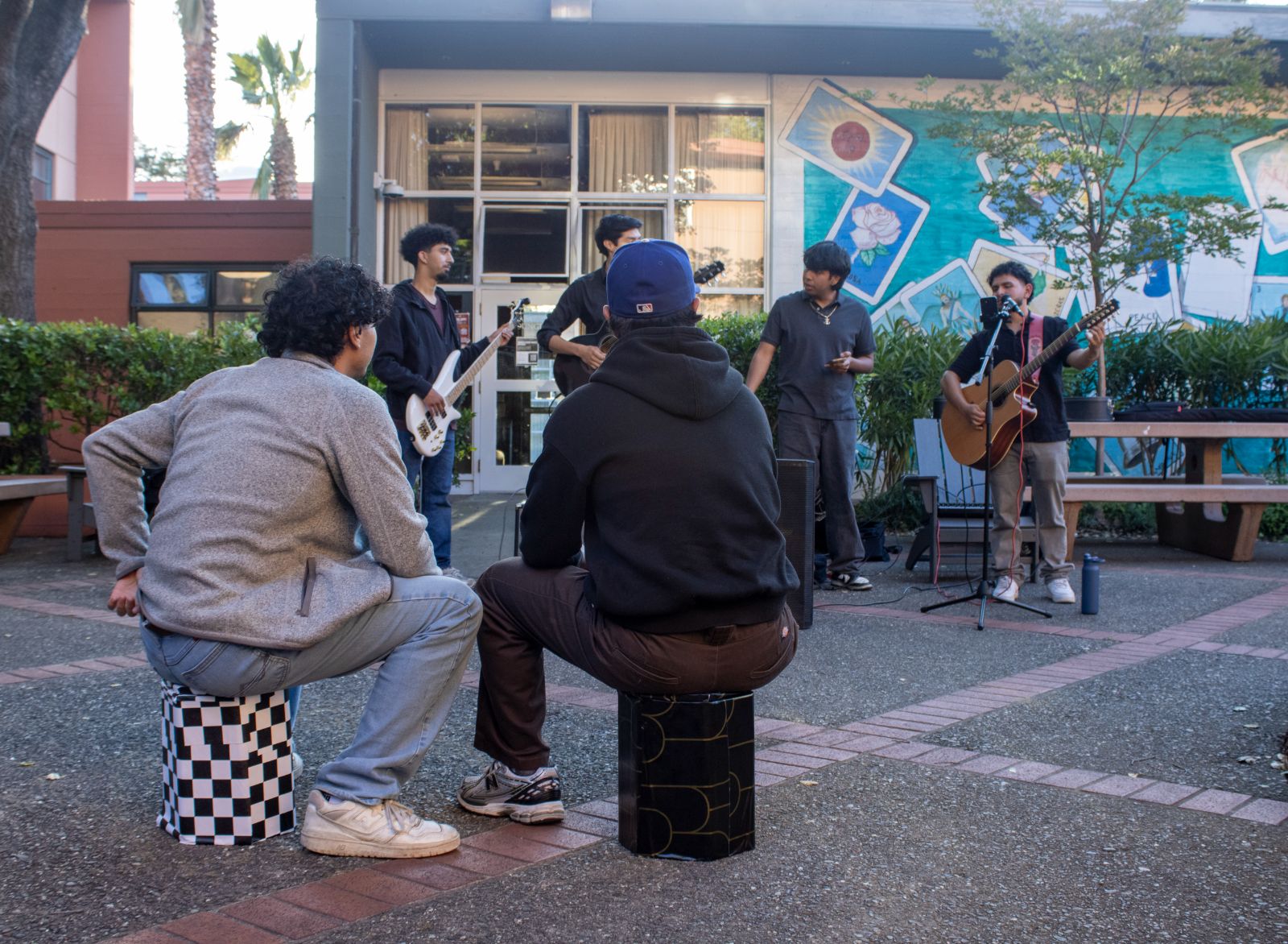 Audience seated on Street Seats watching a student band perform outdoors
