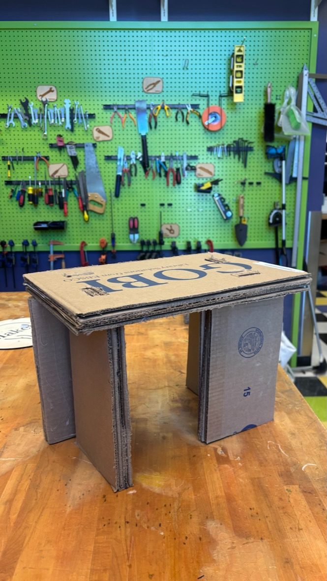 Lo-fi cardboard stool prototype made from corrugated book boxes