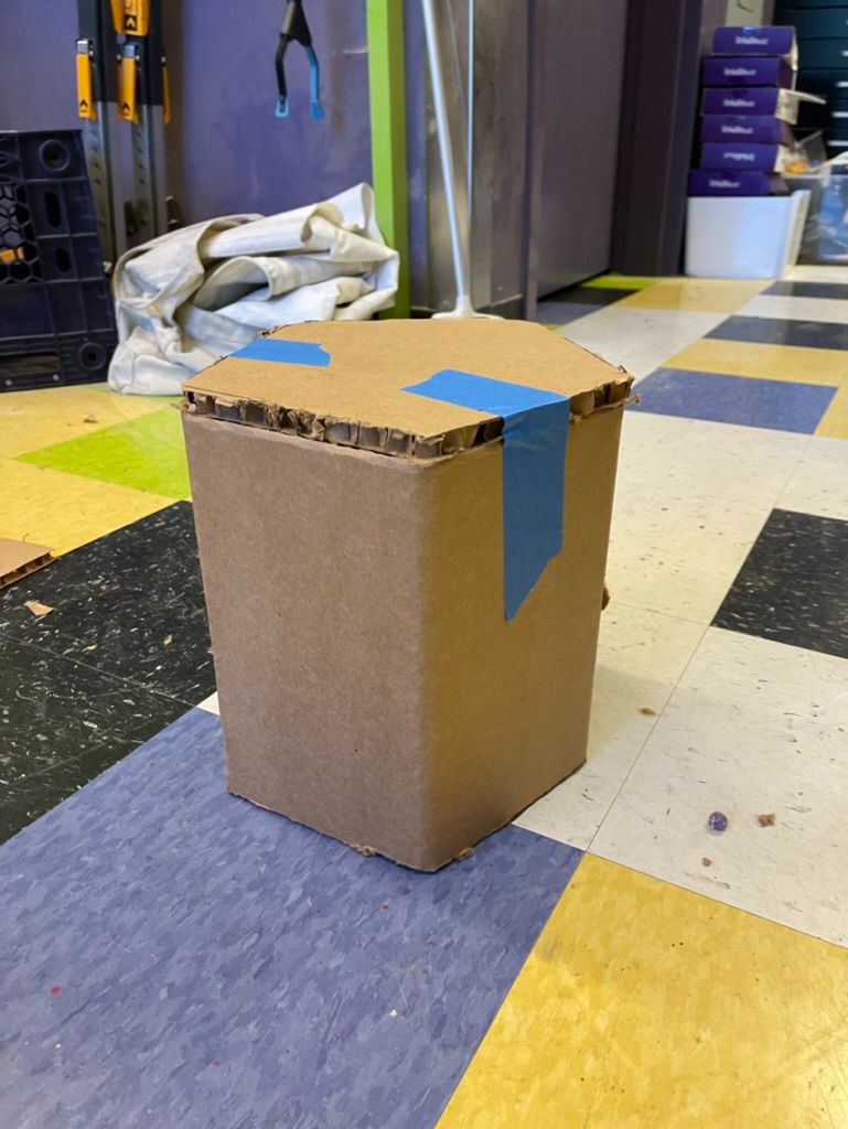 Finished cardboard stool prototype on the studio floor